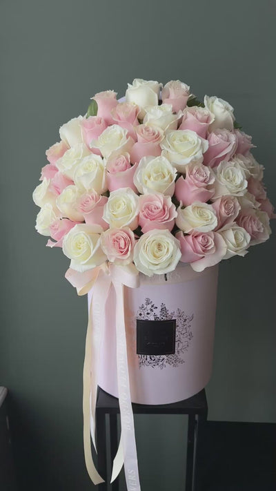 "50 Reasons Why" arrangement: 50 premium roses in a refined box design with a front-facing display. Includes wet floral sponge. Design confirmed in Chicago.