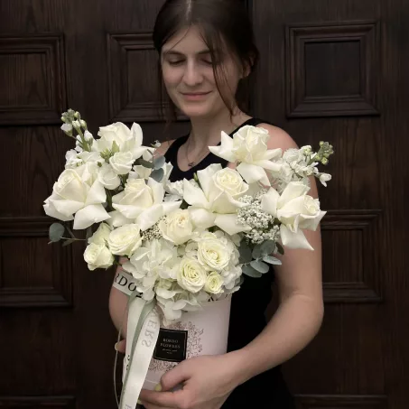 The "Anghelina" box arrangement is a stunning display of elegance and purity, featuring an exquisite selection of all-white flowers. Perfectly crafted for those who appreciate the beauty of simplicity, this arrangement embodies serenity and sophistication. Available in small, medium, and large sizes, "Anghelina" makes an ideal gift for special occasions or as a lovely addition to any space, radiating a sense of calm and freshness. Whether it's a gesture of love, a celebration, or just because, this pure arrangement is sure to delight anyone who receives it.