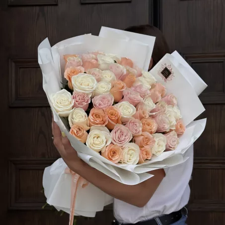 Introducing our stunning Bouquet of 50 Colored Roses, a delightful arrangement that embodies lightness, purity, and elegance. This exquisite bouquet features a beautiful selection of roses in soft, harmonious hues such as white, pink, peach, and beige. Each rose is carefully chosen for its freshness and quality, ensuring a breathtaking display that captures the essence of grace. You can opt for a classic monochromatic look with a single color or create a captivating mix of your favorite shades to suit your personal style. This bouquet is perfect for any occasion, whether it's a romantic gesture, a celebration of friendship, or a heartfelt expression of love. With its enchanting colors and luxurious design, this bouquet is sure to make a lasting impression and brighten any space.