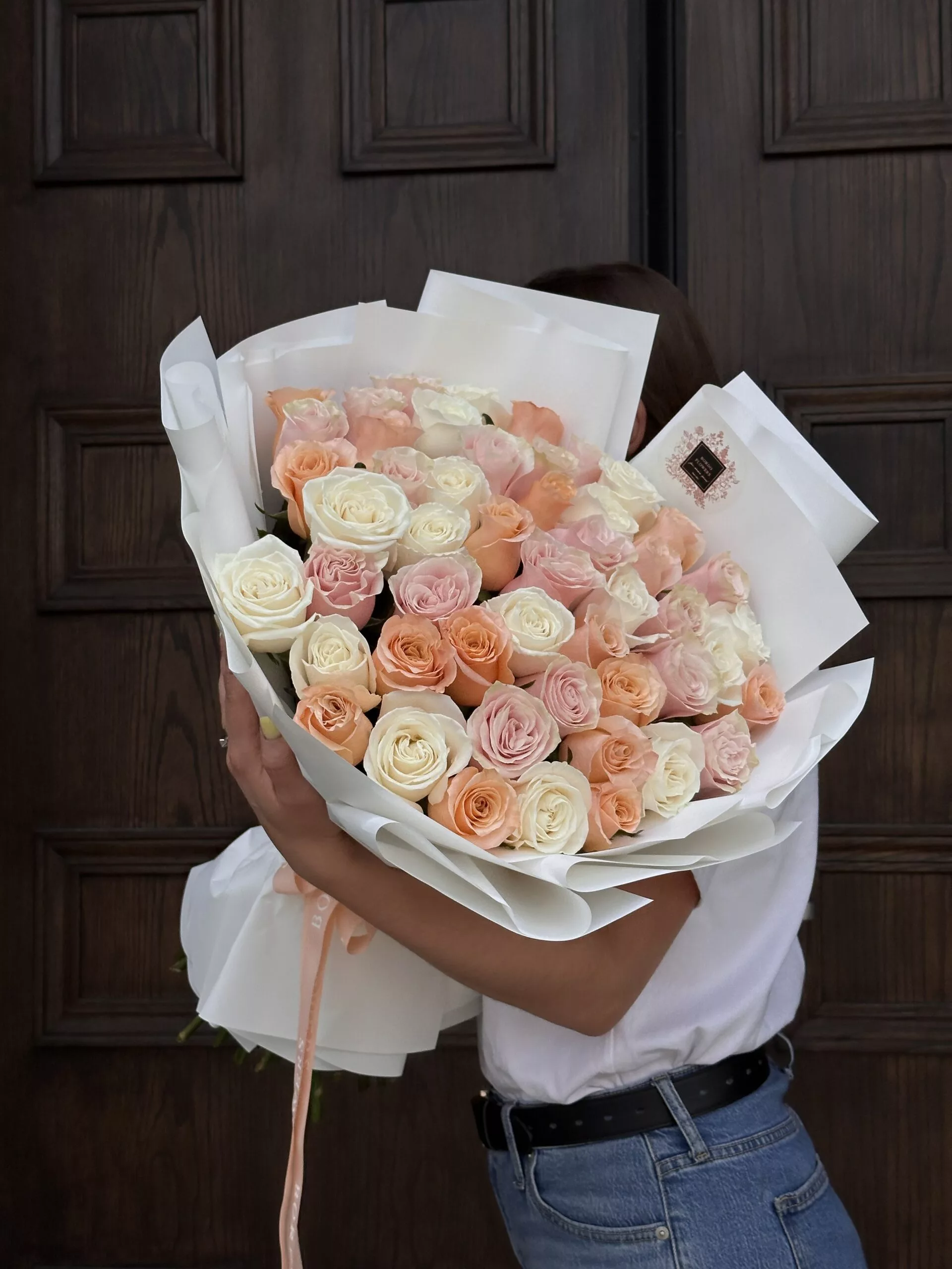 "50 color roses in a bouquet" - Bordo Flowers Introducing our stunning Bouquet of 50 Colored Roses, a delightful arrangement that embodies lightness, purity, and elegance. This exquisite bouquet features a beautiful selection of roses in soft, harmonious hues such as white, pink, peach, and beige. Each rose is carefully chosen for its freshness and quality, ensuring a breathtaking display that captures the essence of grace. You can opt for a classic monochromatic look with a single color or create a captivating mix of your favorite shades to suit your personal style. This bouquet is perfect for any occasion, whether it's a romantic gesture, a celebration of friendship, or a heartfelt expression of love. With its enchanting colors and luxurious design, this bouquet is sure to make a lasting impression and brighten any space.
