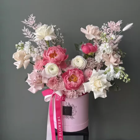 "Raspberry Tart"- A spring arrangement with vibrant raspberry pink blooms and complemented by soft beige accents, this stunning display exudes elegance and sweetness. Each flower is thoughtfully arranged to create a harmonious blend of color and texture, making it a perfect gift or centerpiece for any occasion. The arrangement is presented in a pink box, adorned with a matching tones of pink ribbons, adding a touch of sophistication and playful to the design.