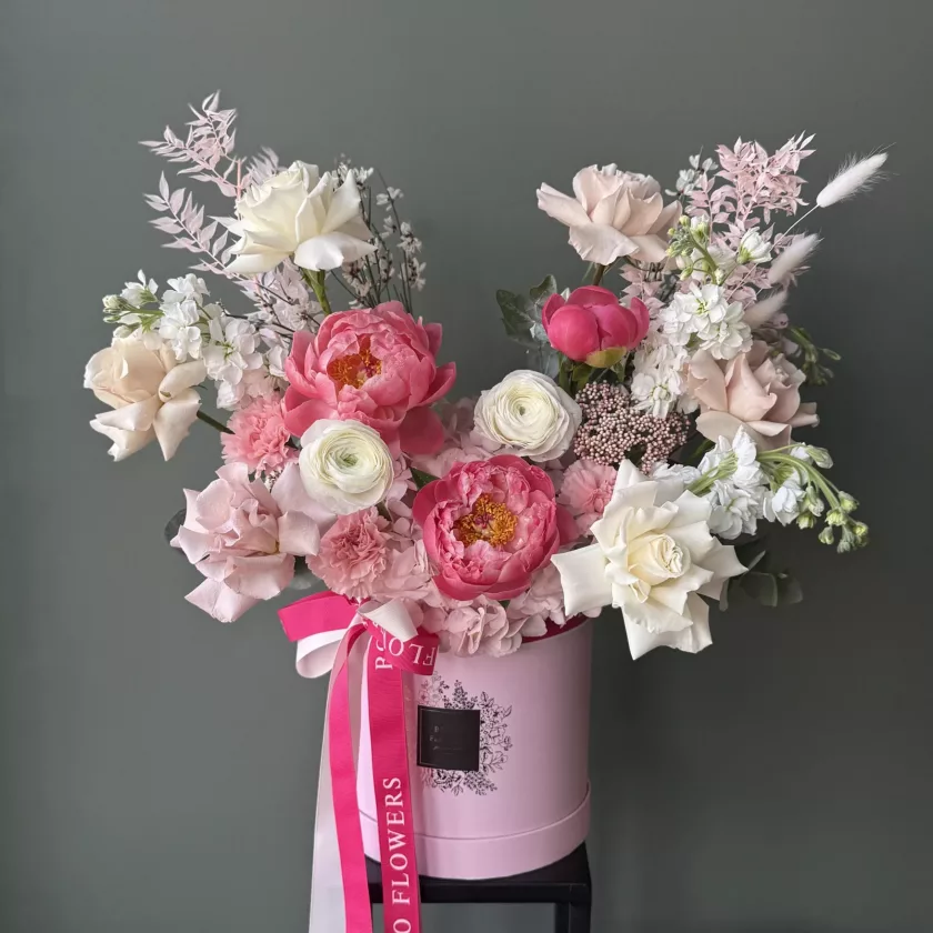 "Raspberry Tart"- A spring arrangement with vibrant raspberry pink blooms and complemented by soft beige accents, this stunning display exudes elegance and sweetness. Each flower is thoughtfully arranged to create a harmonious blend of color and texture, making it a perfect gift or centerpiece for any occasion. The arrangement is presented in a pink box, adorned with a matching tones of pink ribbons, adding a touch of sophistication and playful to the design.